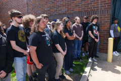 Group of people standing in front of a building, posing for a photo.